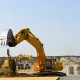 Yellow bulldozer machines digging and moving earth at construction site